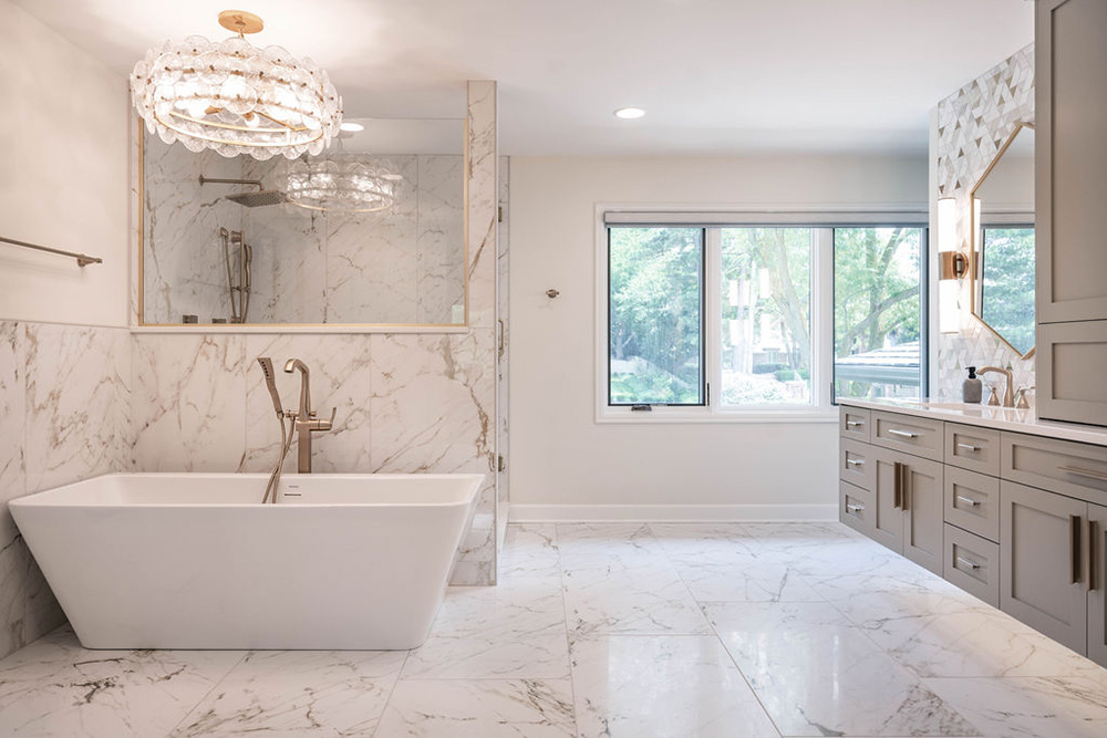 Omaha Home, Kitchen, Bathroom and Basement Remodeling - A modern bathroom with white walls adorned with black geometric patterns, a wooden vanity with a white countertop, an integrated sink, and a black mirror. patterned floor tiles and angled ceiling add visual interest.